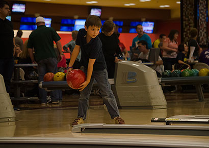 Kid bowling at Strikes for Scholarships